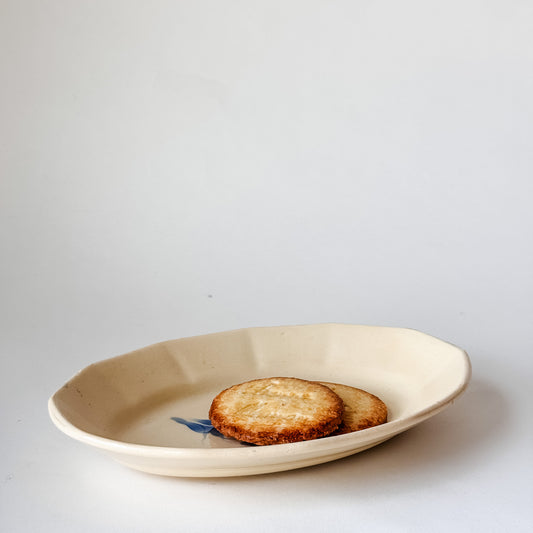 Small Appetizer Dish With a Blue Flower in the Middle