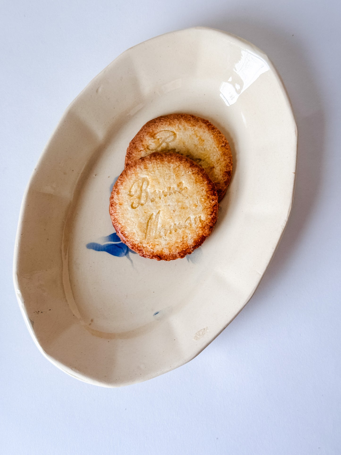 Small Appetizer Dish With a Blue Flower in the Middle